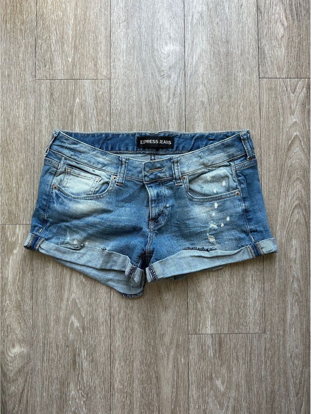 Express Women's low rise medium wash distressed demin shorts